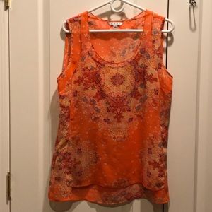 Sleeveless blouse in orange floral. Fully lined